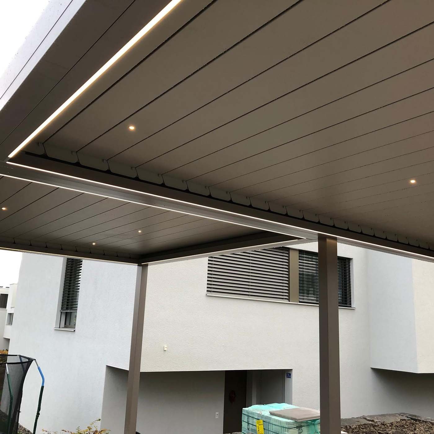 Untersicht eines Lamellendachs mit geschlossenen Lamellen und eingebauten Lichtlinien